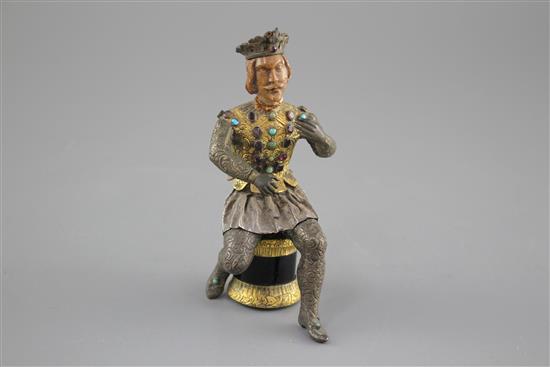 An Austro-Hungarian gilt and white metal figure of a seated knight, with jewelled decoration and hardwood head, height 11.5cm